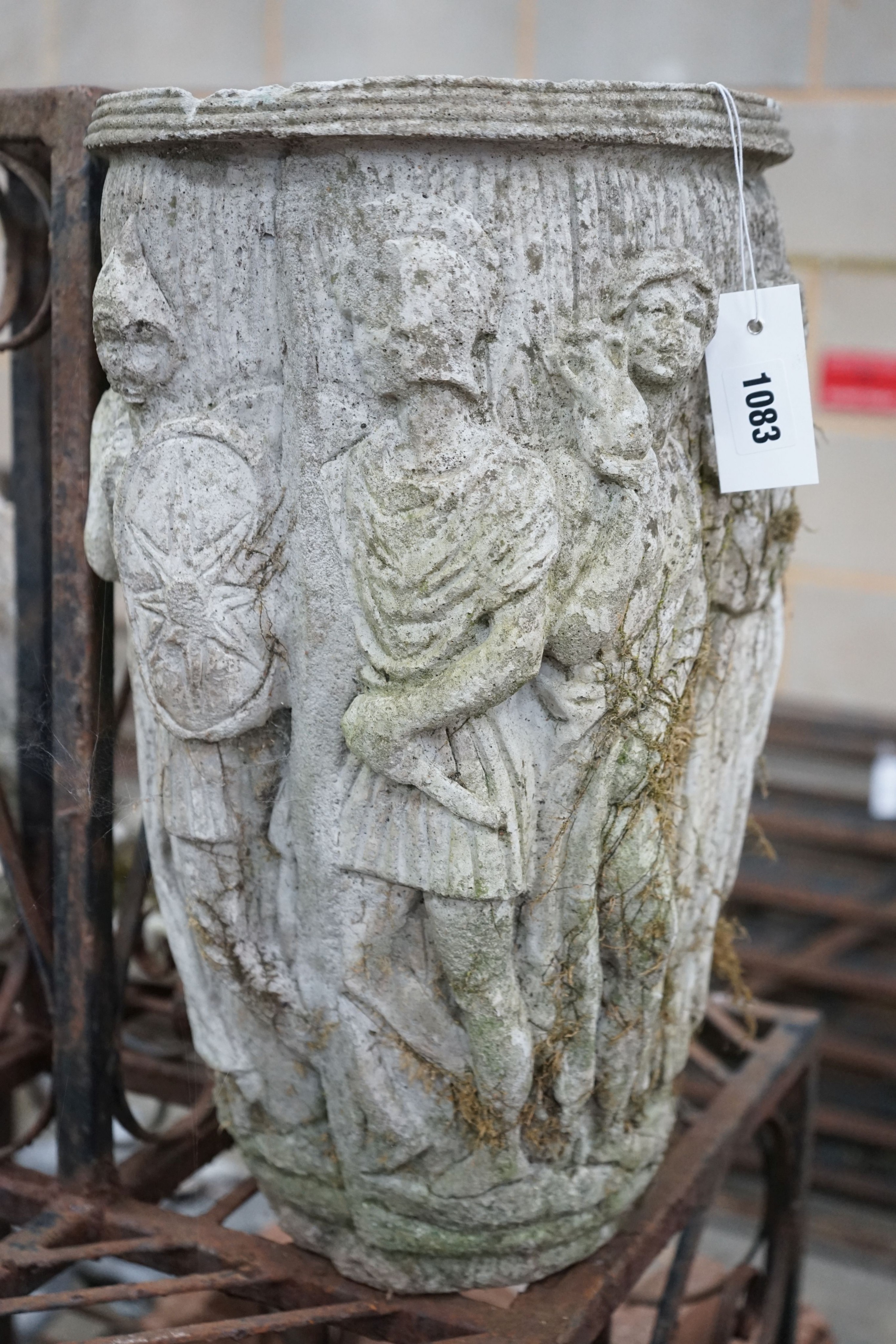 An oval reconstituted stone garden planter moulded with classical figures, height 47cm